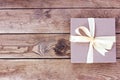 Kraft box for gifts tied with a bow on wooden boards Royalty Free Stock Photo