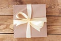 Kraft box for gifts tied with a bow on wooden boards Royalty Free Stock Photo