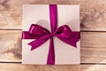 Kraft box for gifts tied with a bow on wooden boards Royalty Free Stock Photo