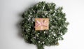 Kraft cardboard gift box tied with rough jute rope on gray wooden background with branches of Christmas tree and Royalty Free Stock Photo
