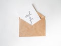 Kraft envelope with a white card with a message - Made for you on white background