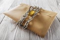 Kraft envelopes with letters and padlock, chain on old white wooden background. Protection of your post, PC mailing. Blanks for th