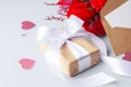 Kraft gift box and white bow with heart paper, rose and card Royalty Free Stock Photo