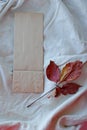 Kraft paper bags with autumn leaves on vintage linen fabric background