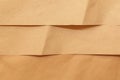 Kraft paper. Brown background for design. Wavy beige paper. Wrinkled craft paper. Craft cardboard texture background. Royalty Free Stock Photo