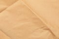 Kraft paper. Brown background for design. Wavy beige paper. Wrinkled craft paper. Craft cardboard texture background. Royalty Free Stock Photo