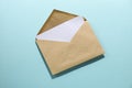 Kraft paper envelope with letter on light blue background, top view. Mockup for design Royalty Free Stock Photo