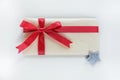 A kraft paper envelope tied with a red festive ribbon is meant to be a gift for Royalty Free Stock Photo