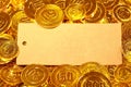 Kraft paper postcard in gold coins heap Royalty Free Stock Photo