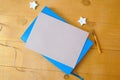 Kraft paper sheet with space for your text on a blue notepad. Flat lay, top view photo mockup