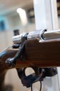 Ornate cut metal part on a hunting rifle, in selective focus.
