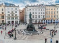 Krakau August 21th 2017: Tourists passing the fountain on Rynek