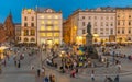 Krakow market square and people having social gathering by the statue of Adam Mickiewicz to support Ukraine. Poland su.