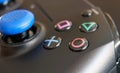 Krakow, Poland: A close up extreme selective focus of the iconic Play station buttons on a wireless controller.