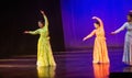Krakow, Poland - April 01, 2019: Girls dressed up in Indian traditional dress and performing Indian classical dance on stage