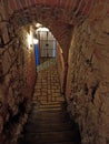 Krakow, Poland: Interior of a basement with narrow stairs made of cobble stone based on Polish architecture theme