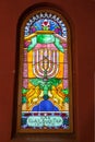 Krakow, POLAND - April, 2019: Multi-colored window stained glass inside the Jewish synagogue. Image of minors and two lions.