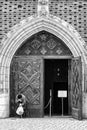 Beggar in front open doors in church Royalty Free Stock Photo