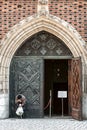 Beggar in front open doors in church Royalty Free Stock Photo