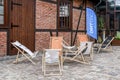 KRAKOW,POLAND - AUGUST 16, 2018: Street cafe corner with deck chairs in front of old brick wall. Kazimierz district