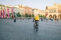 Krakow, Poland - 25 August 2022: An unidentified Glovo bike courier on the street in Krakow, Poland. Delivery of food