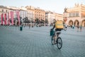 Krakow, Poland - 25 August 2022: An unidentified Glovo bike courier on the street in Krakow, Poland. Delivery of food