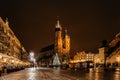 Krakow,Poland.Basilica of Saint Mary and famous Christmas market on main square,Rynek Glowny at night,decorated timber huts and Royalty Free Stock Photo