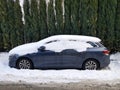 KRAKOW, POLAND, 2021 - Blue car covered with snow. Parking on the street near home in european city. Royalty Free Stock Photo