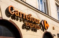 Krakow, Poland, Carrefour Express brand signage orange logo closeup outdoors, shop chain convenience store building facade