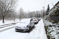 KRAKOW, POLAND, 2021 - Cars parked along the city street, covered with thick layer of fresh white snow. Royalty Free Stock Photo