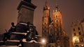 The Statue Of Adam Mickiewicz And Saint Mary's Basilica Twin Tower During Nighttime