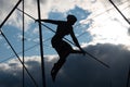 Krakow, Poland - December 13, 2019: Backlit gymnast sculpture on a cloudy sunset at Kladka Ojca Bernatka in Krakow, Poland