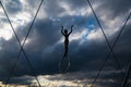Krakow, Poland Ã¢â¬â December 13, 2019: Backlit gymnast sculpture with a hoop on a cloudy sunset at Kladka Ojca Bernatka in Krakow,