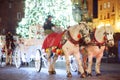 Krakow, Poland - December 2, 2021: decorated carts with horses are waiting for tourists for traditional horse rides in the old