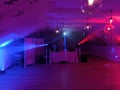 Krakow, Poland: An empty dance floor with illuminated colorful disco spot lights. ready for a dance party and