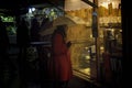 Krakow, Poland - December 22, 2014: A girl in red coat holding umbrella in front of waffle shop during Christmas eve holidays in