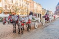 KRAKOW, POLAND - DECEMBER 2, 2017: Old-fashioned Horse drawn carriages at Rynek Glowny square in Krakow, Pola