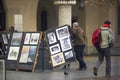 Krakow, Poland : A sketch painting artist stand next to his artwork in city center main square during Xmas
