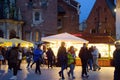 Krakow, Poland - December 2, 2021: Traditional street Christmas fair on a winter day. People celebrating on cozy seasonal European