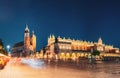 Krakow, Poland. Famous Landmarks On Old Town Square In Summer Evening. St. Mary's Basilica, Cloth Hall Building In Night Royalty Free Stock Photo