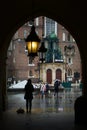 Krakow, Poland - February 23, 2016: View of old Krakow in rainy evening through the archway, Krakow, Poland Royalty Free Stock Photo