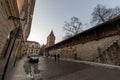 Krakow, Poland - February 20, 2021: Wide angle shot of a european street and people taking a walk during evening in the old town