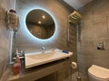 home interior, modern bathroom with big round mirror Royalty Free Stock Photo