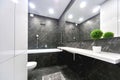 home interior. Modern bathroom in black and white colors with big mirror and marble finishing Royalty Free Stock Photo