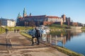 Krakow, POLAND - JANUARY 3, 2018: Mother with child walking along the road to Wawel castle in Krakow city