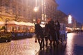 KRAKOW, POLAND - JANUARY 06, 2016: Unknown people have a tourist tour on the horse with carriage on the Main Market Square in Royalty Free Stock Photo