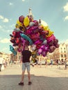 Male street vendor sells colorful popular cartoon character heli