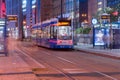 Modern tram of public transport of Krakow next to Galeria Krakowska at night