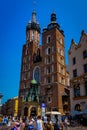 Krakow, Poland - July 19, 2017: People Walk On The Main Square In Royal City Krakow In Poland. In Backdrops St. Mary`s Basilica I