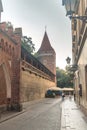 Pijarska street with Haberdasher Tower in Old Town at sunrise Royalty Free Stock Photo